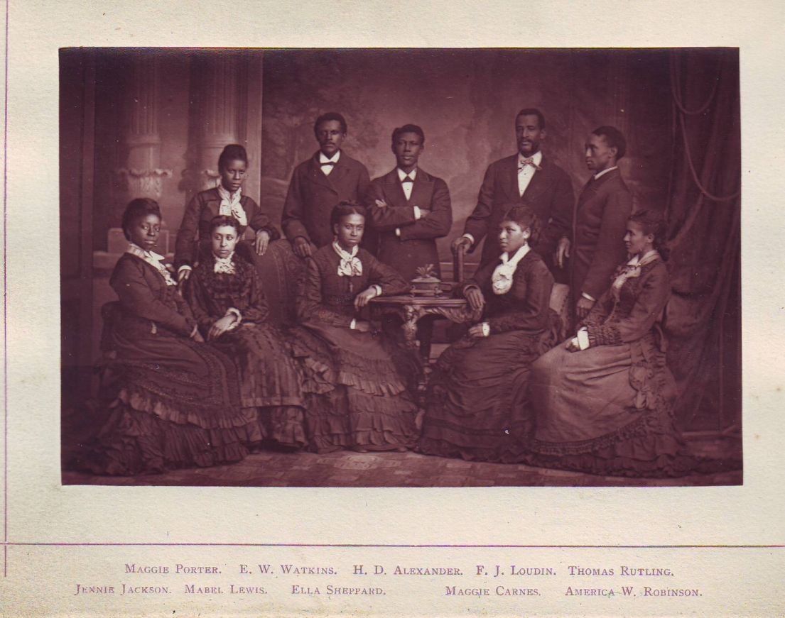 Formal photograph of a group of Victorian men and women.