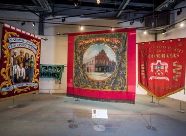 'The big three' banners, 2024 Banner Exhibition at People's History Museum. Image courtesy of People's History Museum.