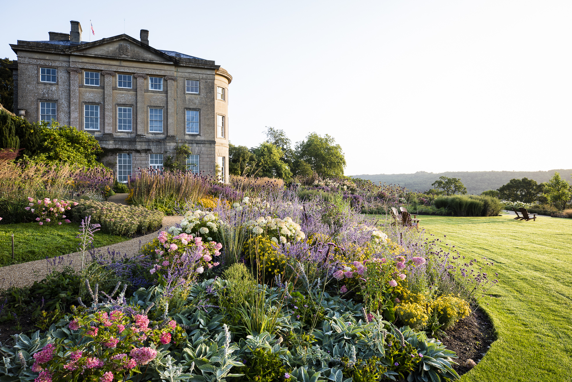 Three-story stone building in beautiful grounds.