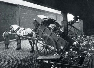 Black and white of a horse and cart tipping