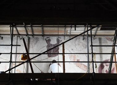 Working hard high up on scaffolding, beneath the angels' feet!