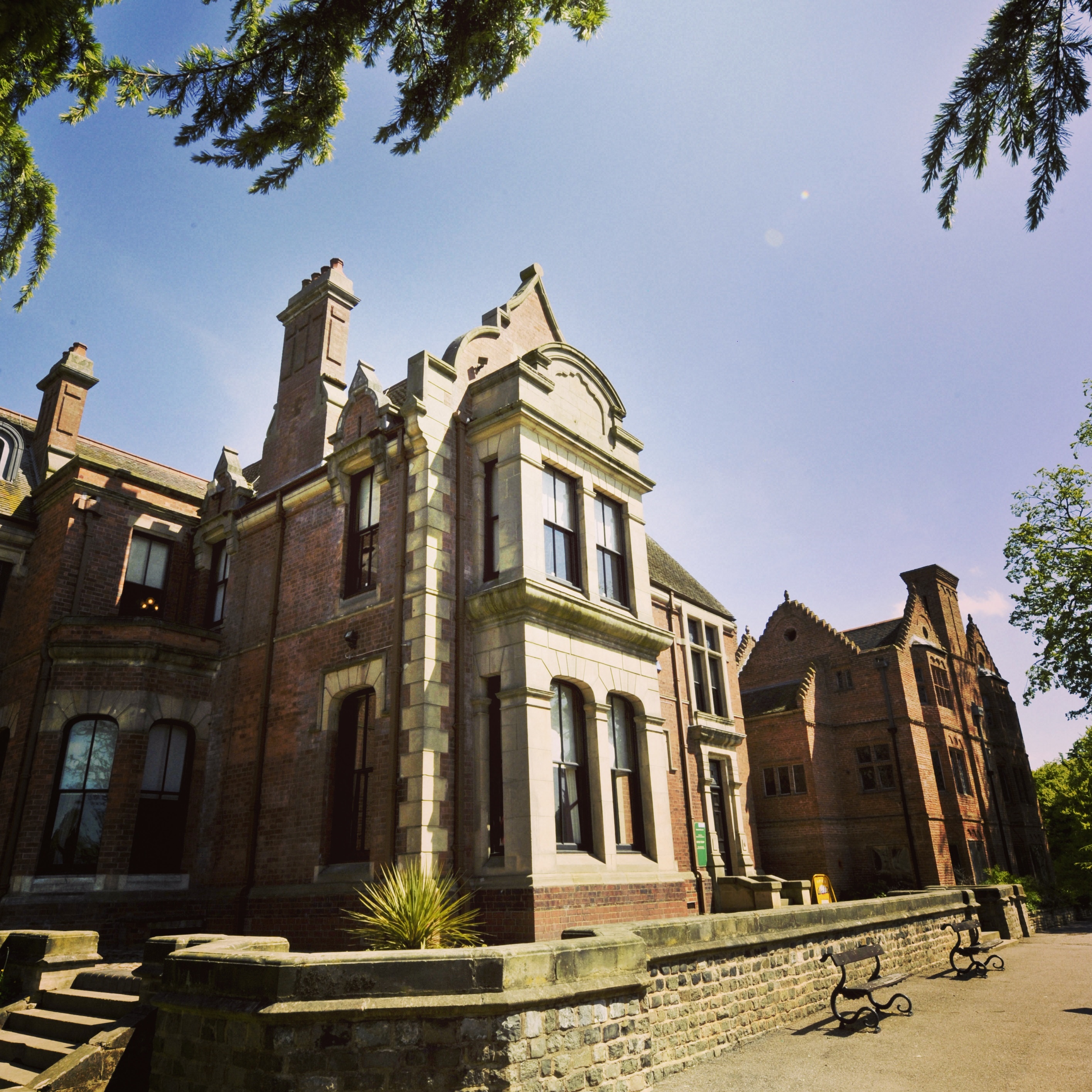 Exterior of a grand, two storey brick house.