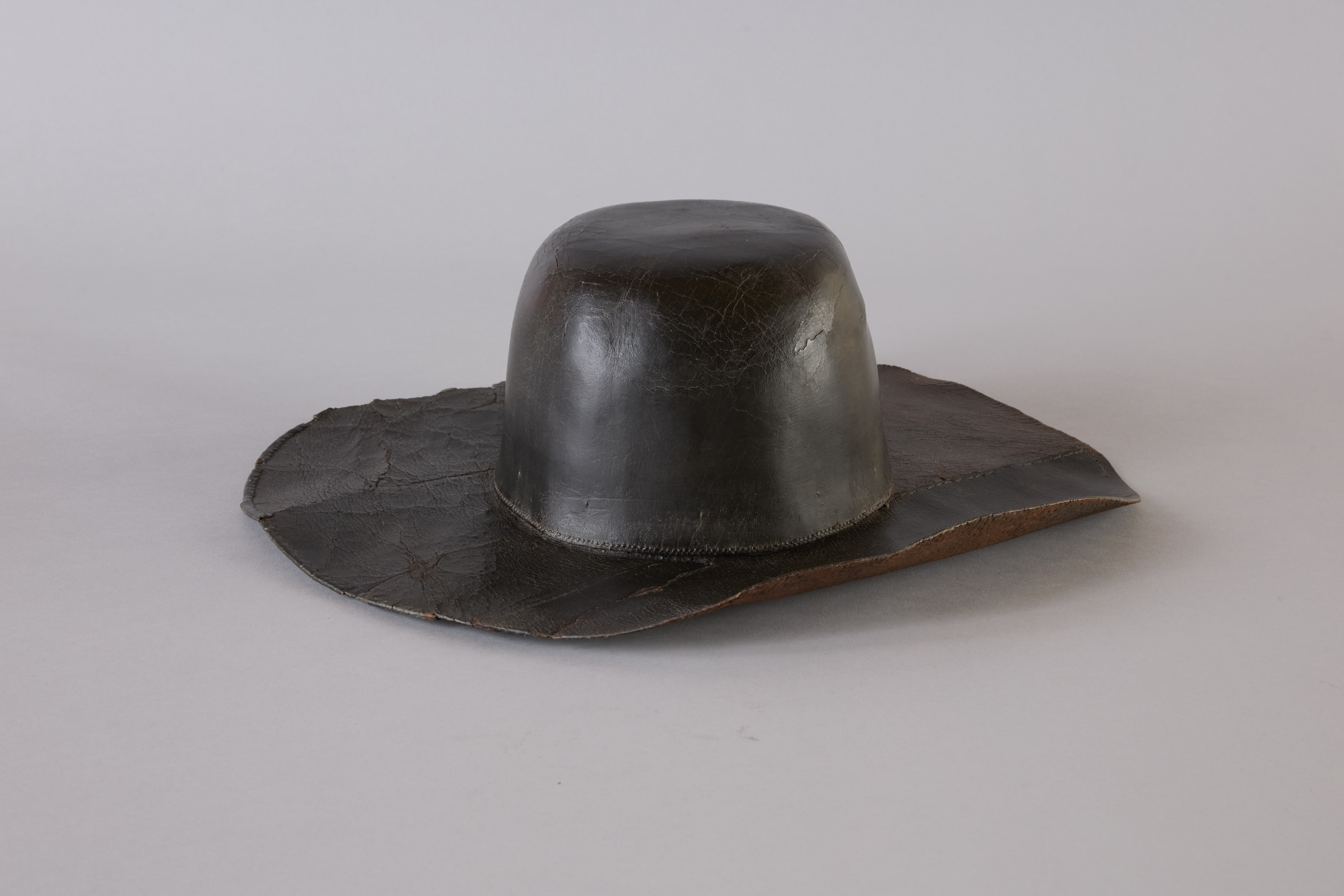 Wide brimmed black leather hat.